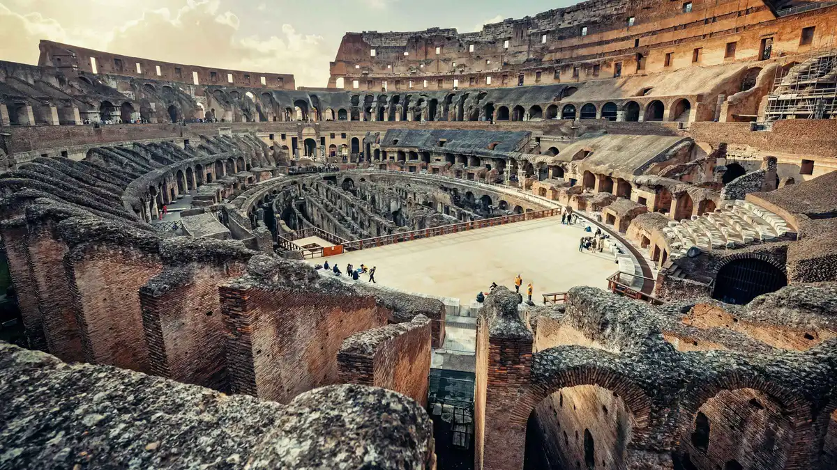 Visitors on the Colosseum arena floor beside the gladiators' gate on an arena and Roman Forum tour in Rome